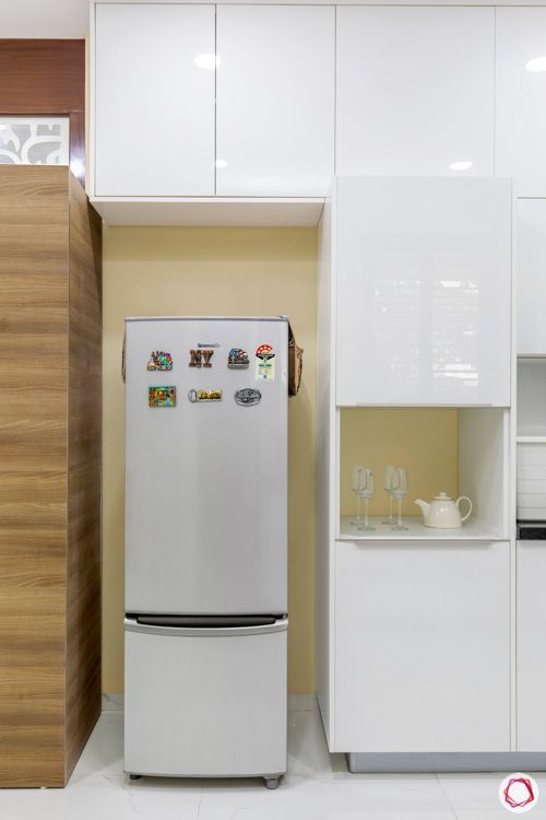 interior design in hyderabad-kitchen-tall unit--fridge-acrylic finish-granite countertop-metallic white cabinets