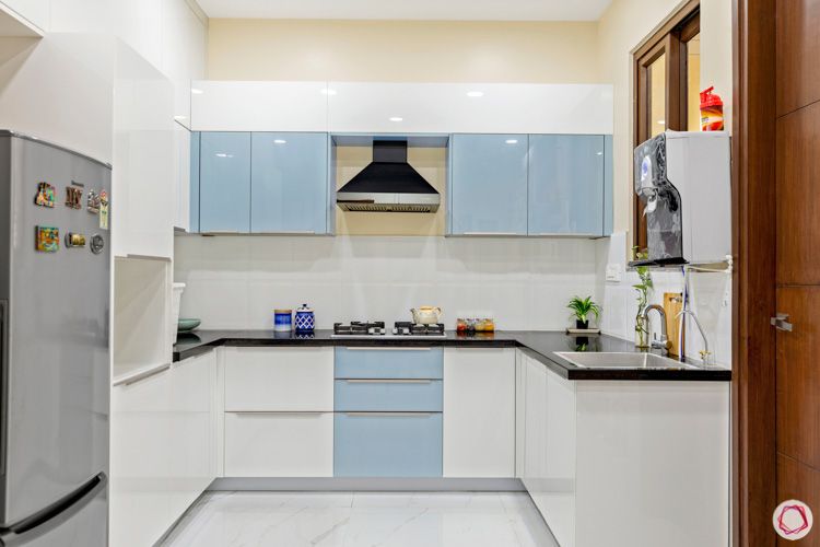 interior design in hyderabad-kitchen-tall unit-chimney-acrylic finish-granite countertop-fridge-profile shutters