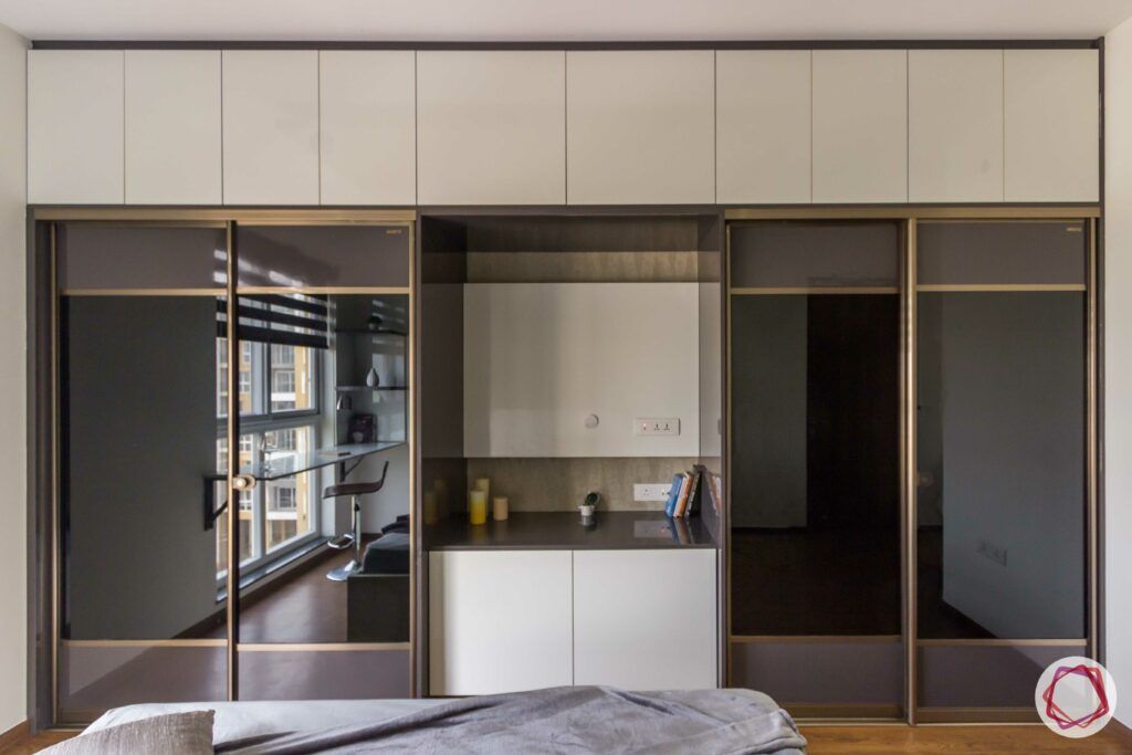 livspace wardrobe design-dark reflective wardrobes-sliding door-wardrobe with tv unit