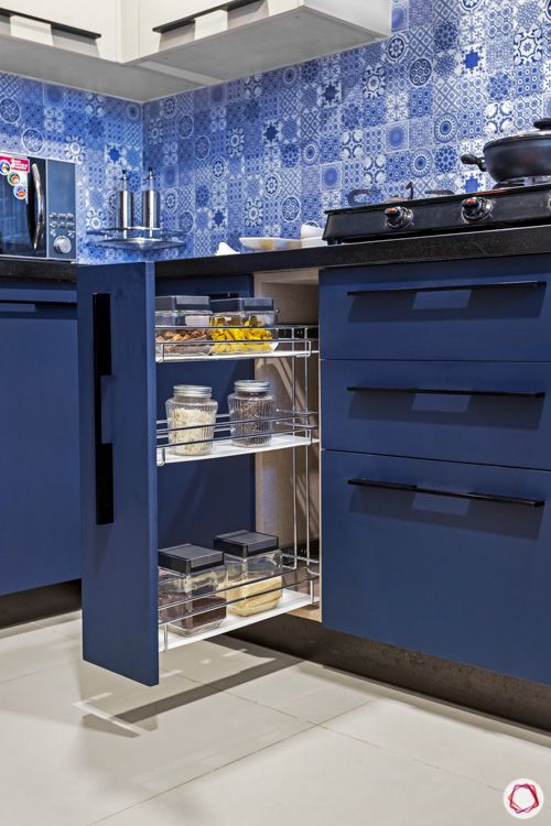 ark blue cabinets-pull out cabinet-blue tiled backsplash