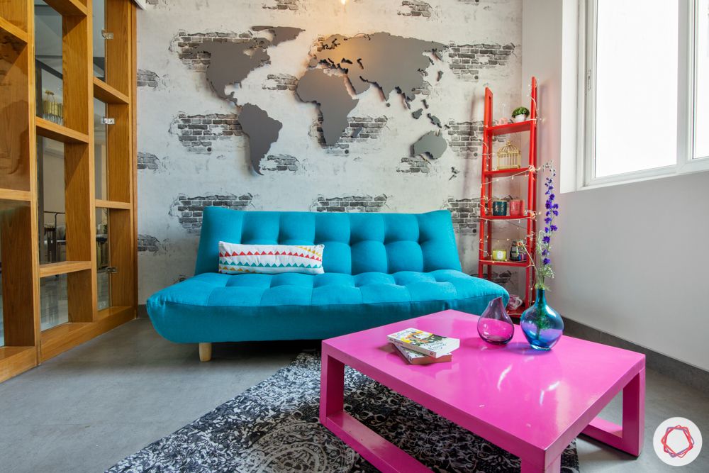 blue sofa-trends 2020-world map wall-futon sofa-pink coffee table
