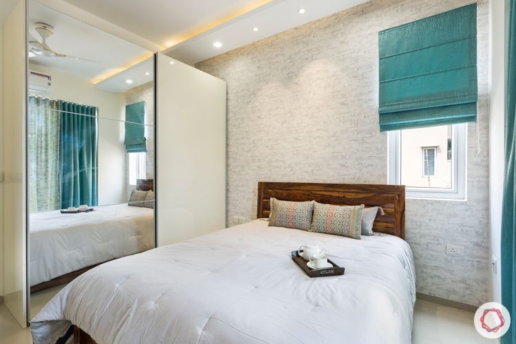 3-bhk-apartment-master-bedroom-exposed-brick-wallpaper-wooden-bed-sliding-wardrobe-mirror-door