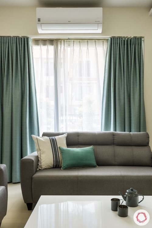 grey textured wallpaper-grey sofa-marcel center table-blue curtains-false ceiling