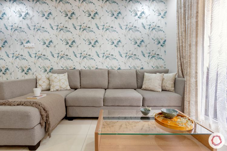 2 bhk flat interior design- grey sofa-floral wallpaper-walnut finish center table