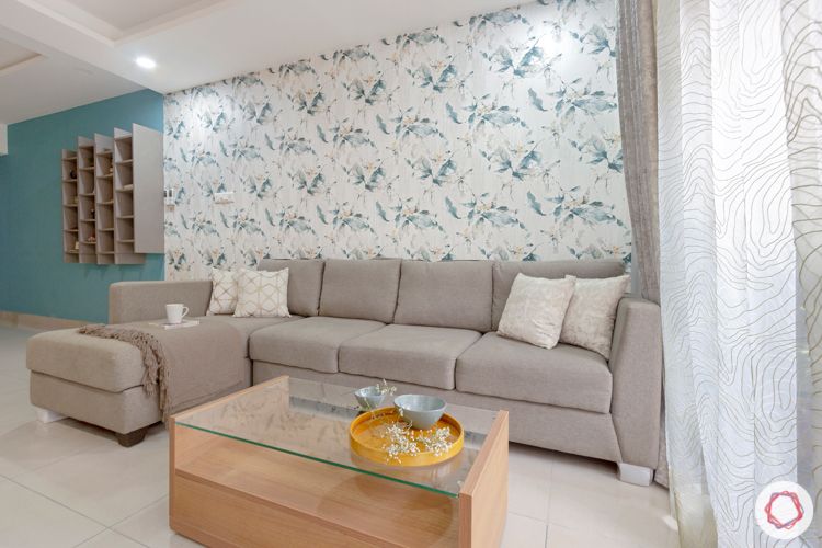 Living room-grey sofa-floral wallpaper-walnut finish center table-grey display unit
