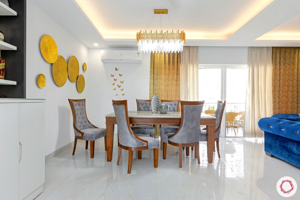  4 bhk home design-chandelier-velvet dining table