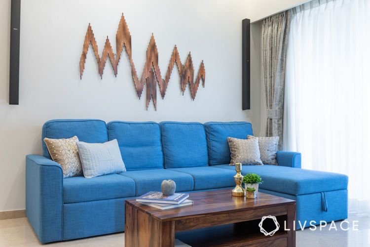 center table buying tips-blue sofa-wooden coffee table-wall mount
