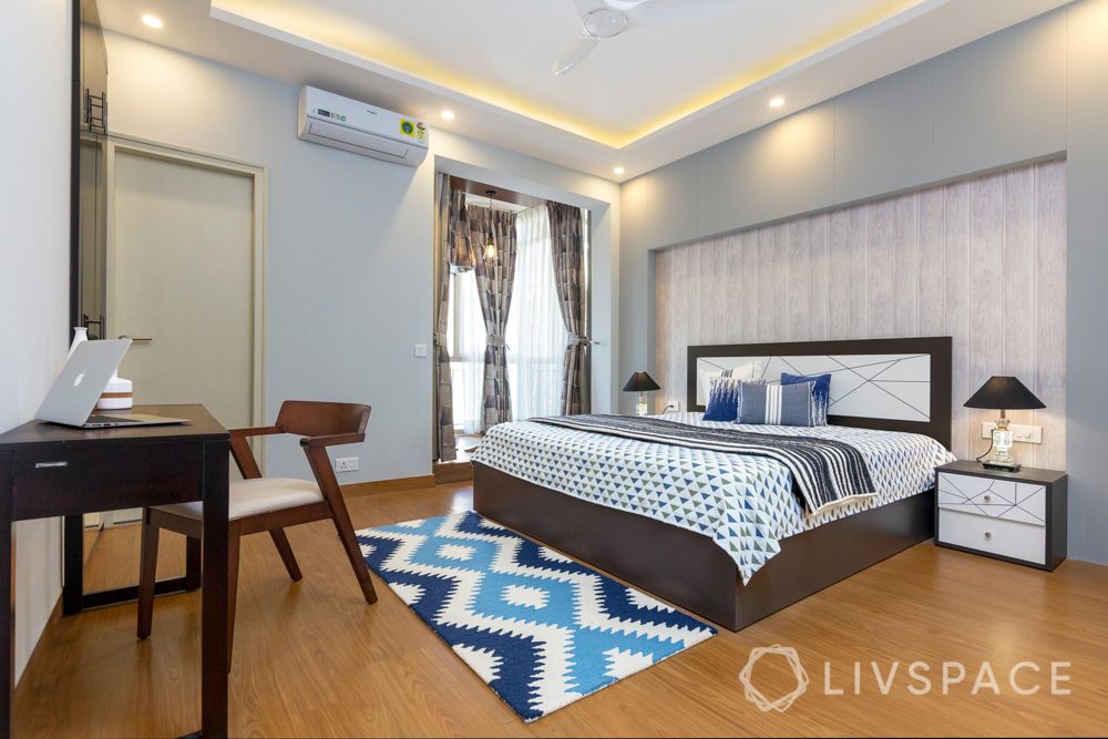 Son bedroom-wooden pattern wallpaper-laminate wardrobe-headboard-cushions-rug-study table-table lamps
