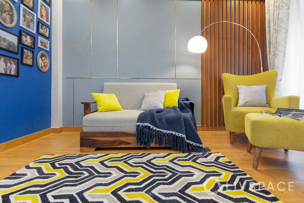 4 BHK flat design-yellow accent chair-rug-floor lamp-sofa-gallery wall-wooden panelling