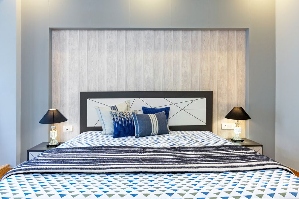 Son bedroom-wooden pattern wallpaper-laminate wardrobe-headboard-cushions-rug-study table-table lamps