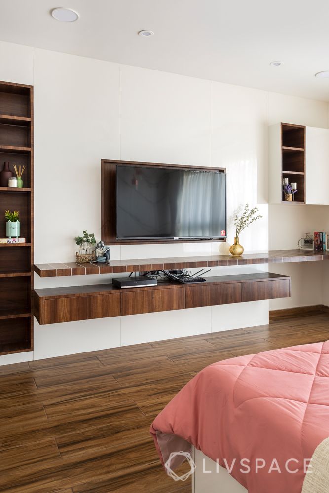 adani western heights andheri-marble wall-hinged wardrobes-gold wall mount-pendant lights-pink bedded-wooden interiors