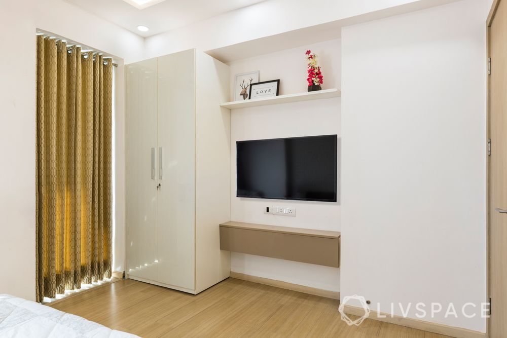 White wardrobe-muted golden tv unit