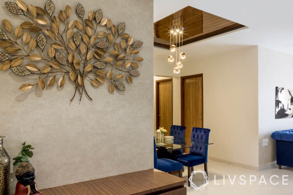 gold wall accents-tree of life-blue sofas