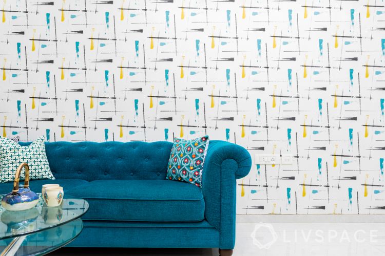 how to decorate home in low budget-blue sofa-pattern wallpaper