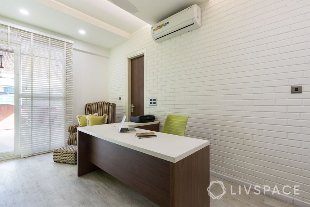 clean white walls-brick wall-armchair-study table