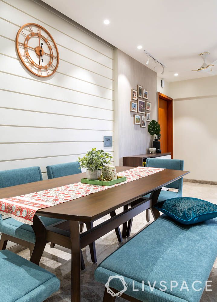 clean white walls-blue bench-wall clock-dining table set 