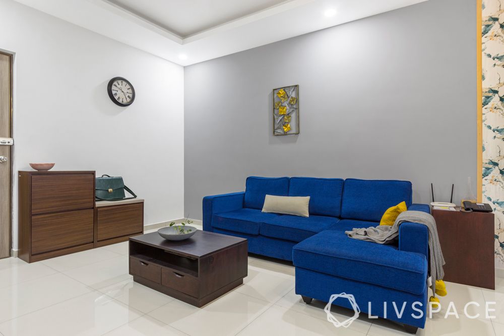 interior design firms in bangalore-blue sofa-grey wall-shoe cabinet-coffee table