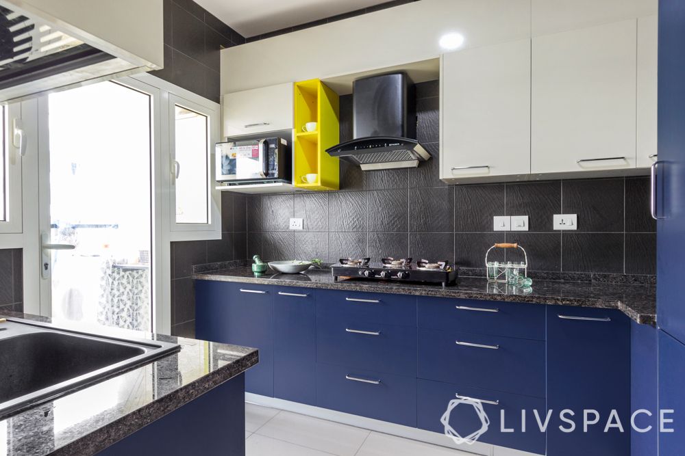 interior design firms in bangalore-textured black tile backsplash-membrane kitchen-yellow open unit