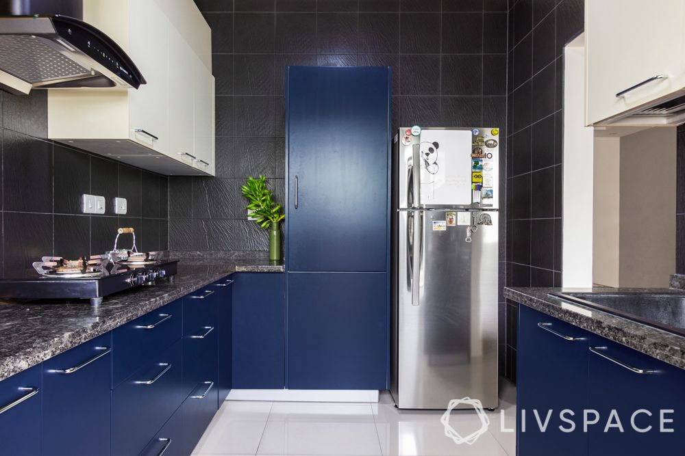 interior design firms in bangalore-tall unit-fridge-membrane kitchen-textured black tiles