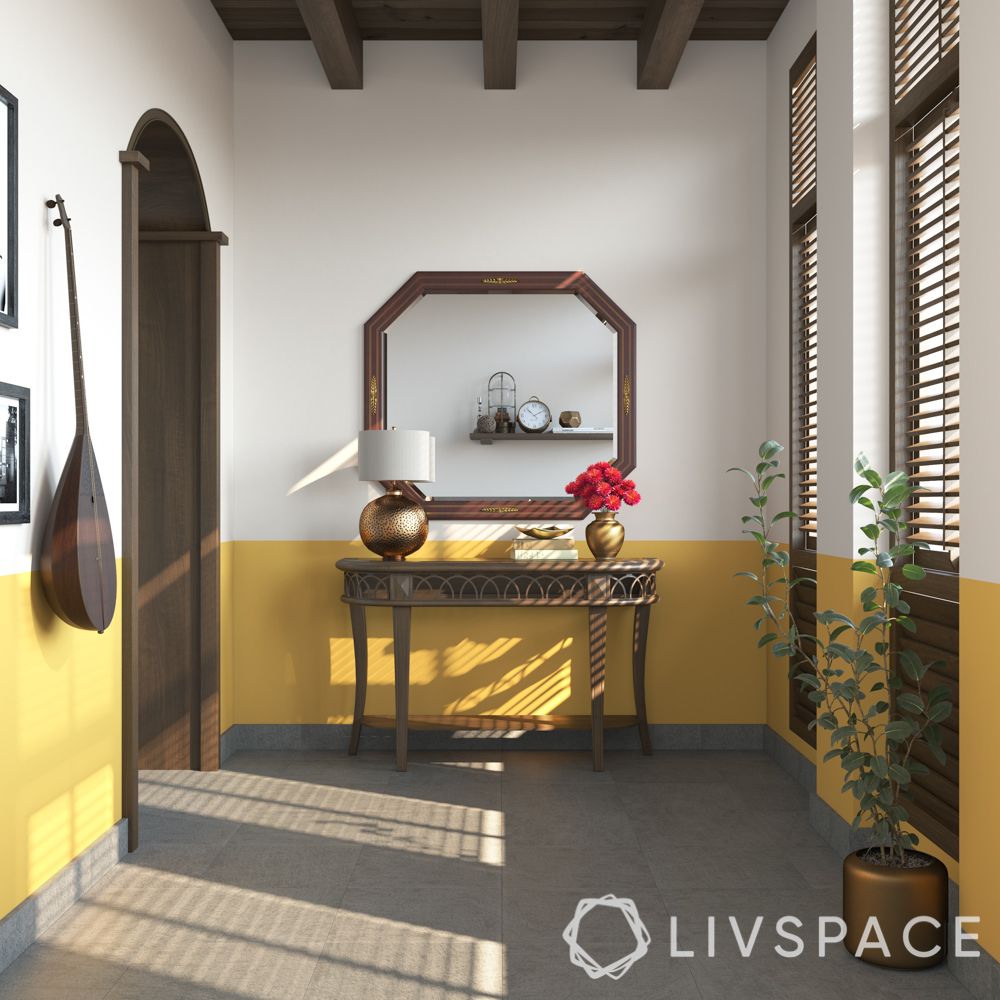 kerala style house-yellow wall colour-wooden console