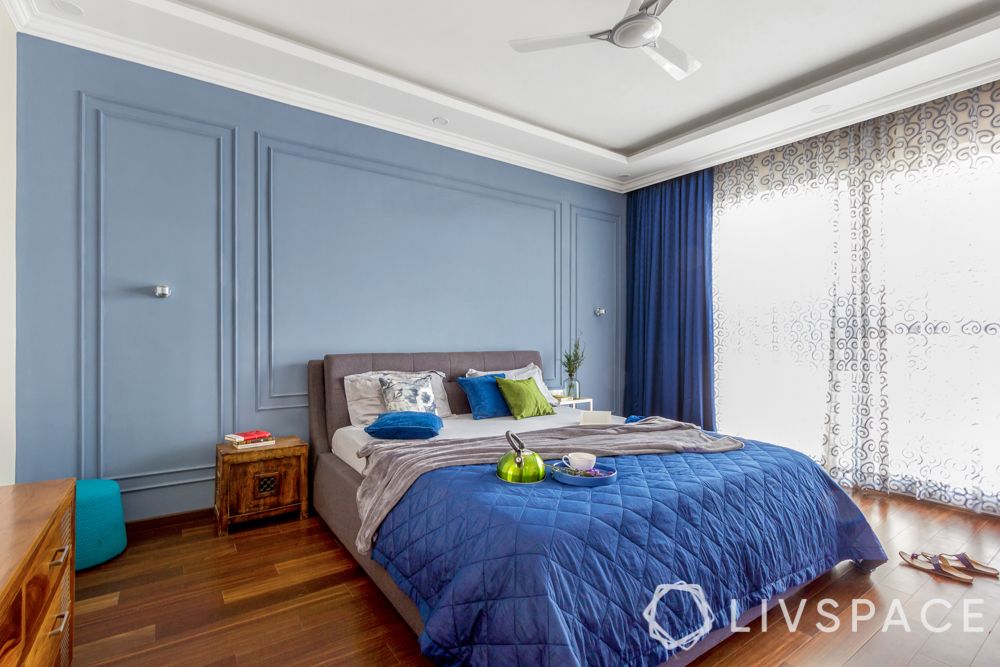 how to make bedroom perfect for sleep-blue bedding-blue wall trims-white curtains-wooden flooring