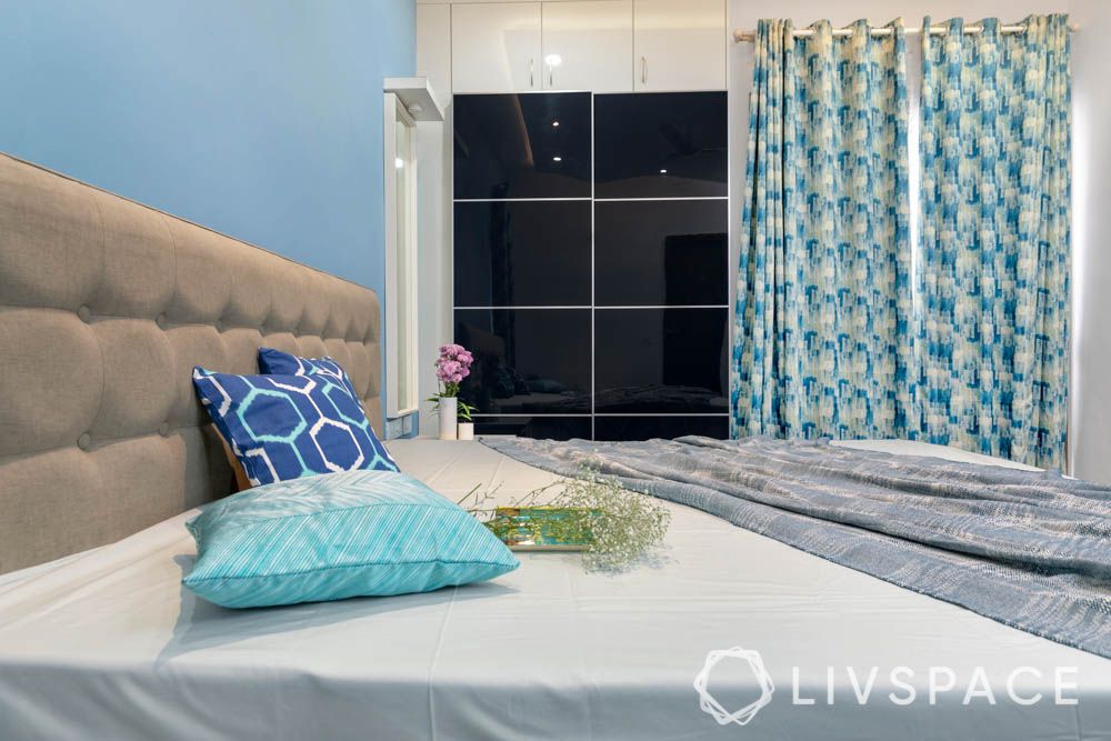 2bhk in hyderabad-master bedroom designs-blue wardrobe-white bed-vanity unit