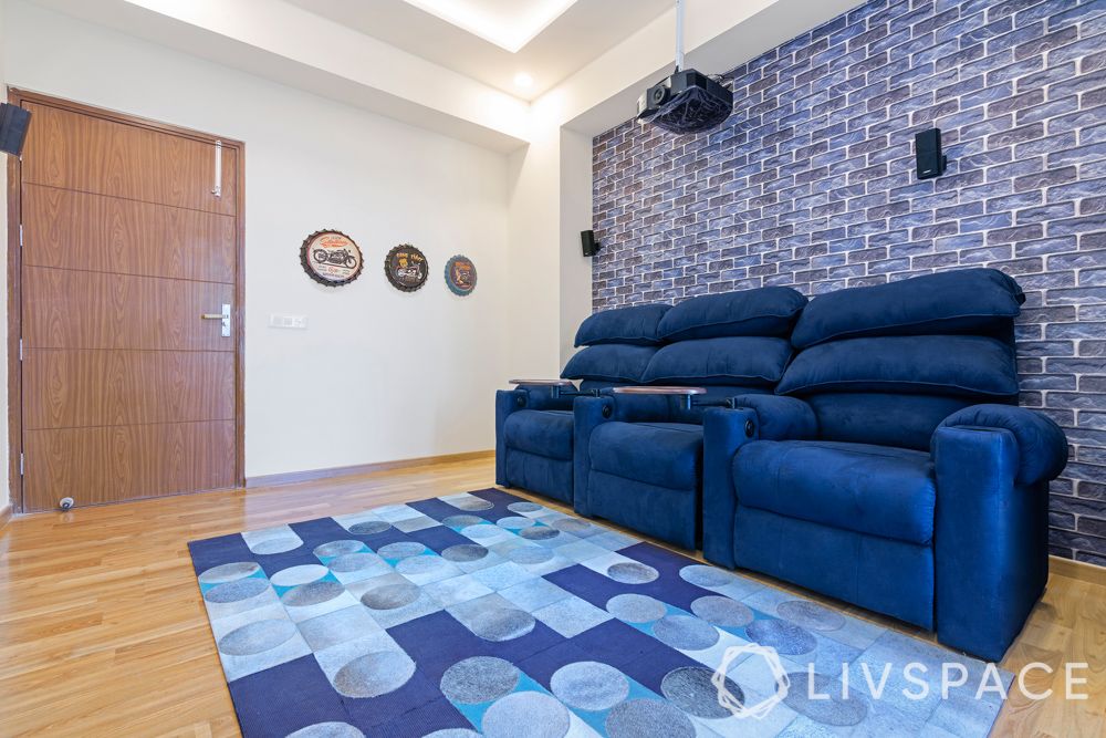 blue recliners-blue exposed brick wall