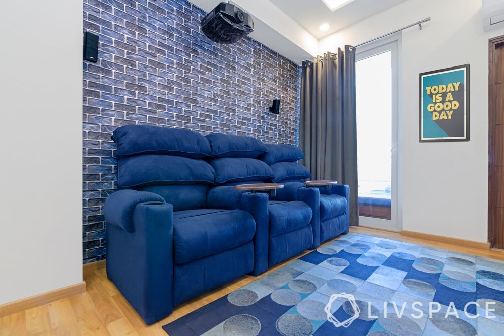 blue recliners-blue exposed brick wall