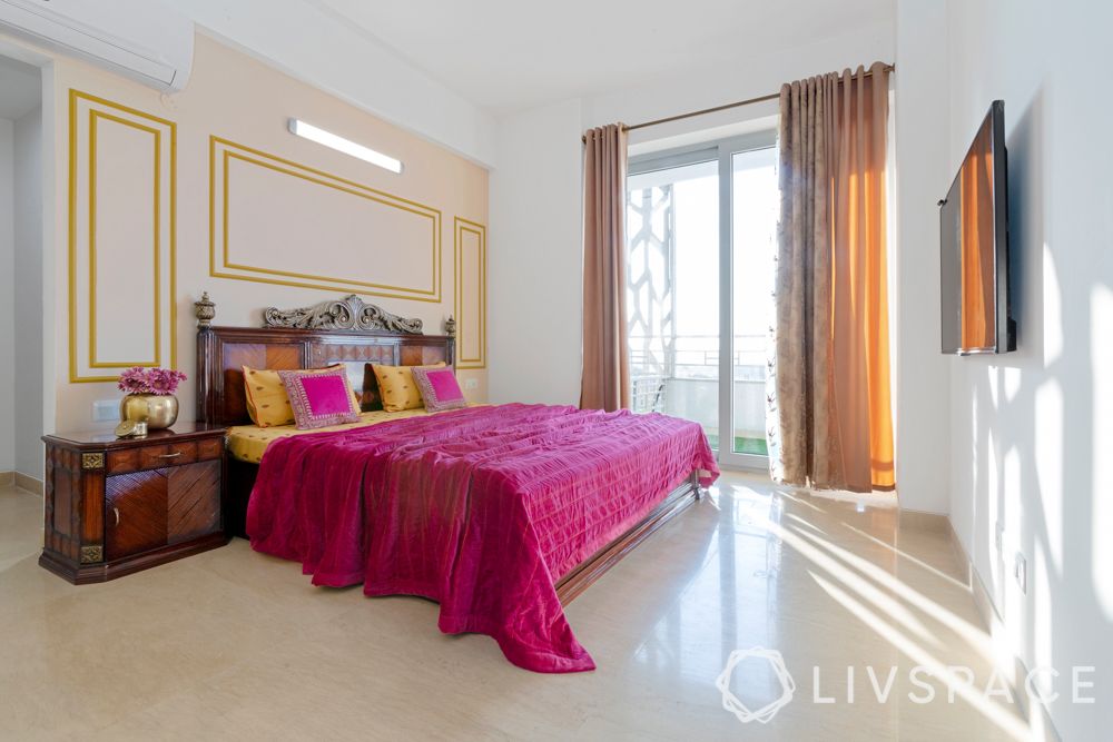 master bedroom-gold wall trims-carved wooden bed