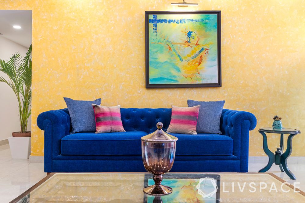 yellow wall-blue couch-living room