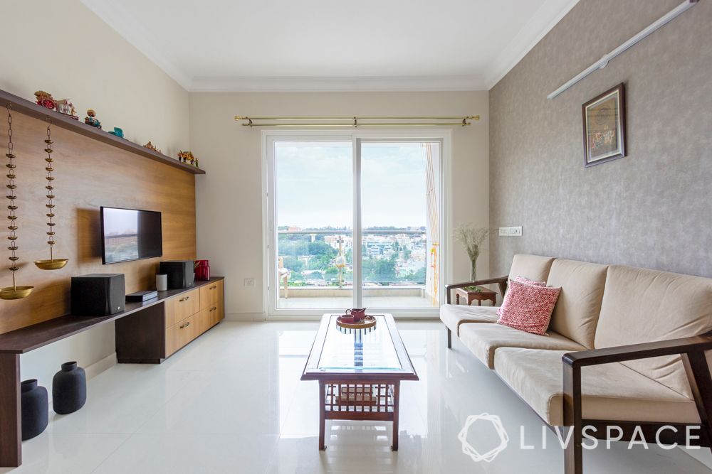 simple interior design-wooden sofa-brass lamps-wooden tv unit-coffee table-grey wallpaper