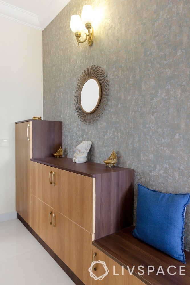 simple interior design-wooden shoe cabinet-brass lamps-mirror designs-sunburst mirror-grey wallpaper