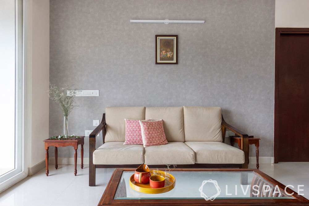 simple interior design-wooden sofa-brass lamps-wooden tv unit-coffee table-grey wallpaper

