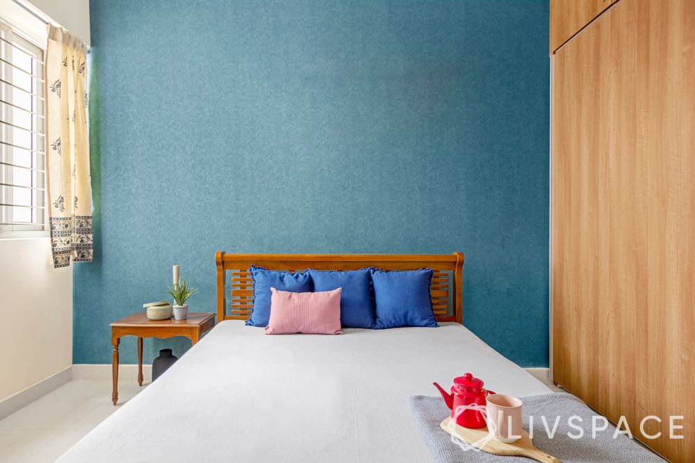 simple interior design-blue wallpaper-wooden wardrobe-wooden bed-side table