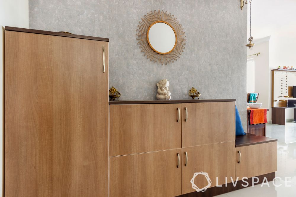 simple interior design-wooden shoe cabinet-brass lamps-mirror designs-sunburst mirror-grey wallpaper