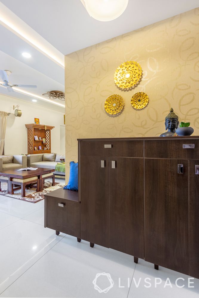 best interiors in bangalore-foyer-shoe cabinet-gold wallpaper-gold wall mount