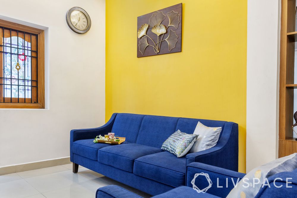 living room-yellow accent wall-blue sofa
