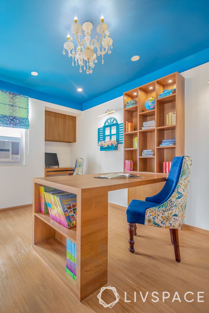 travel-themed interior design-blue and white chair-wooden desk and bookshelf-painted ceiling-white walls