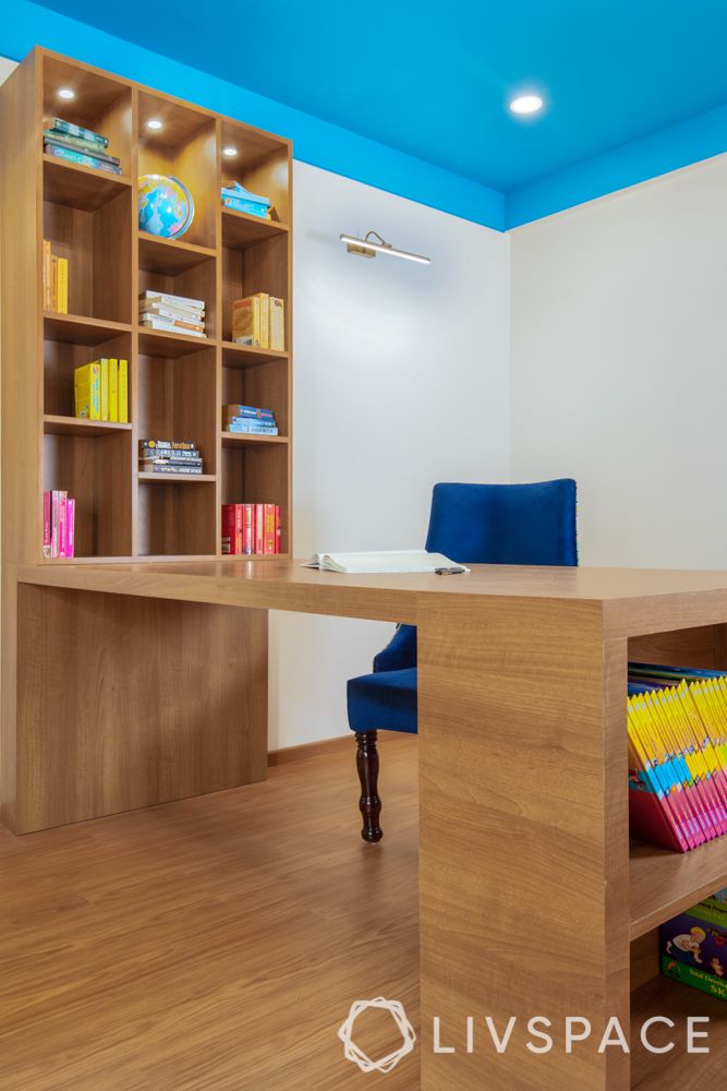 travel-themed interior design-blue and white chair-wooden desk and bookshelf-painted ceiling-white walls