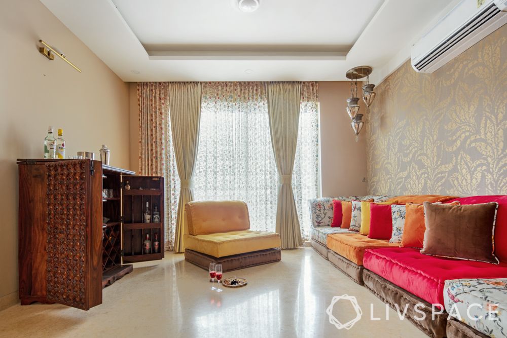 travel-themed interior design-red and yellow seating-wooden bar unit-lanterns-gold wallpaper