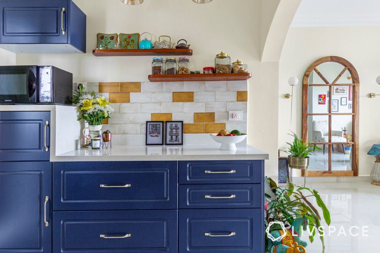 how to clean house-floating shelves-blue cabinets-white countertop