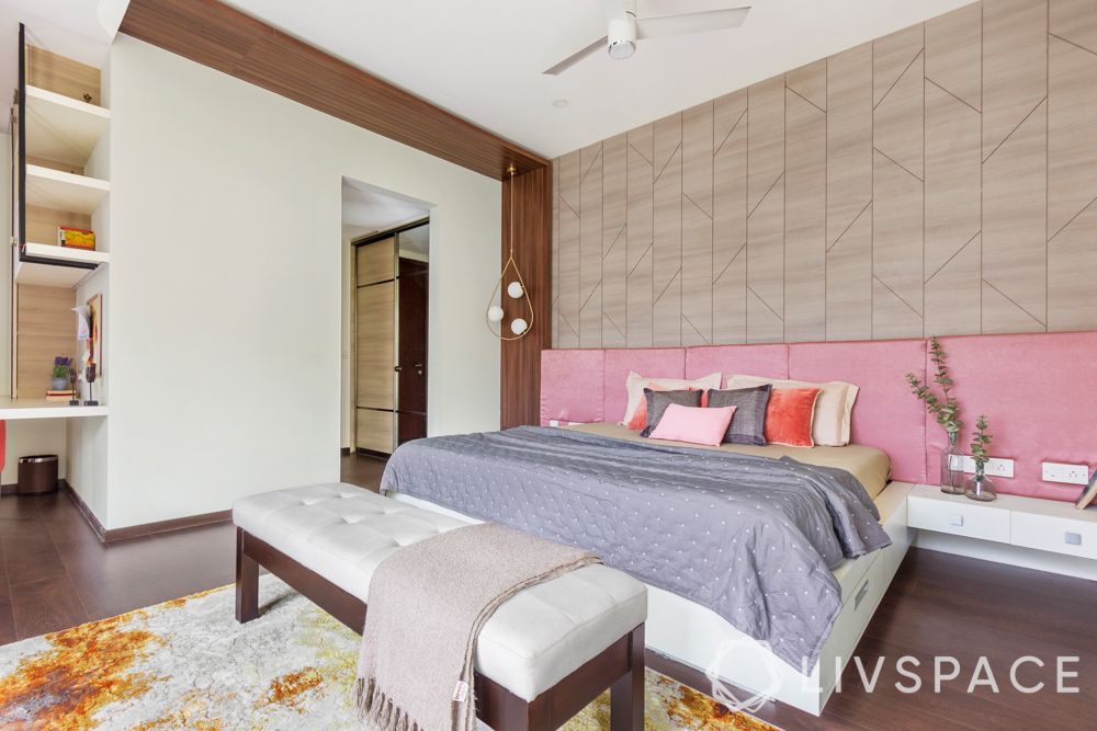 villa house design-wooden panelling-pendant lights-pink headboard-bench-orange armchair-study unit
