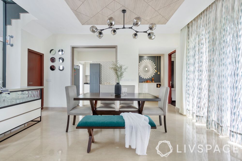 villa house design-blue bench-round mirrors-lighting-wooden false ceiling-crockery unit
