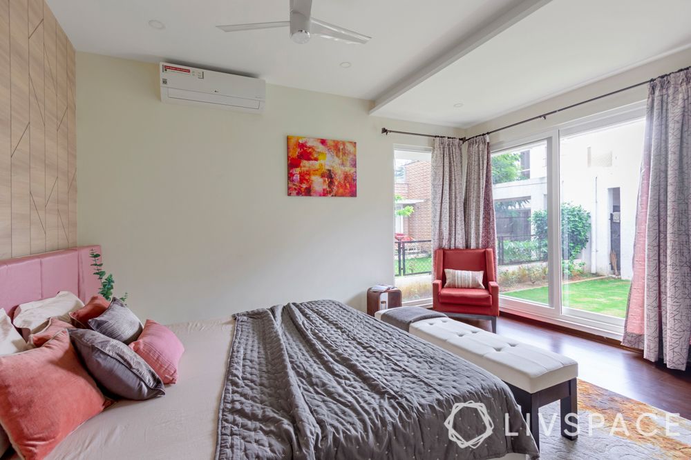 villa house design-wooden panelling-pendant lights-pink headboard-bench-orange armchair-study unit