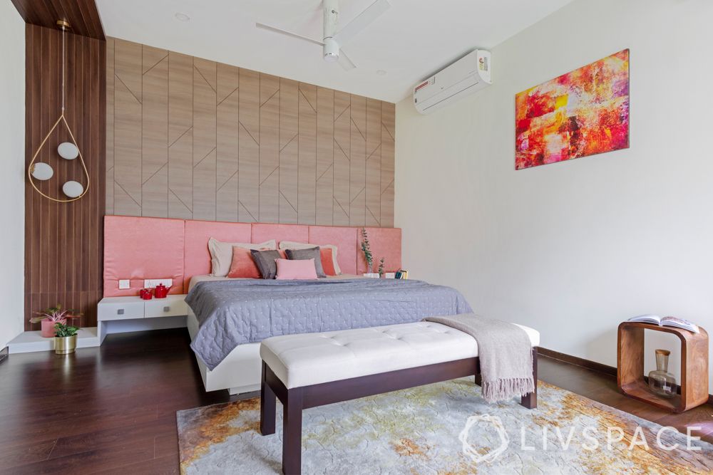 villa house design-wooden panelling-pendant lights-pink headboard-bench-orange armchair-study unit