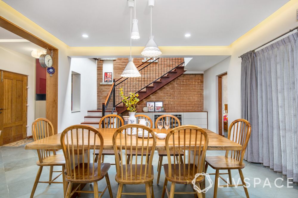 villa interior-wooden dining table-exposed brick wall