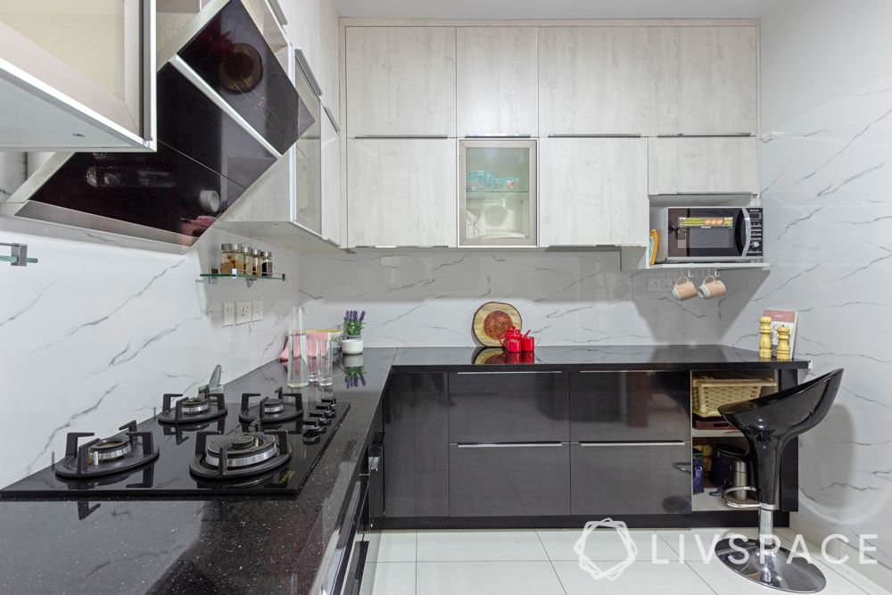 3 bhk interior-grey and white kitchen-black countertop
