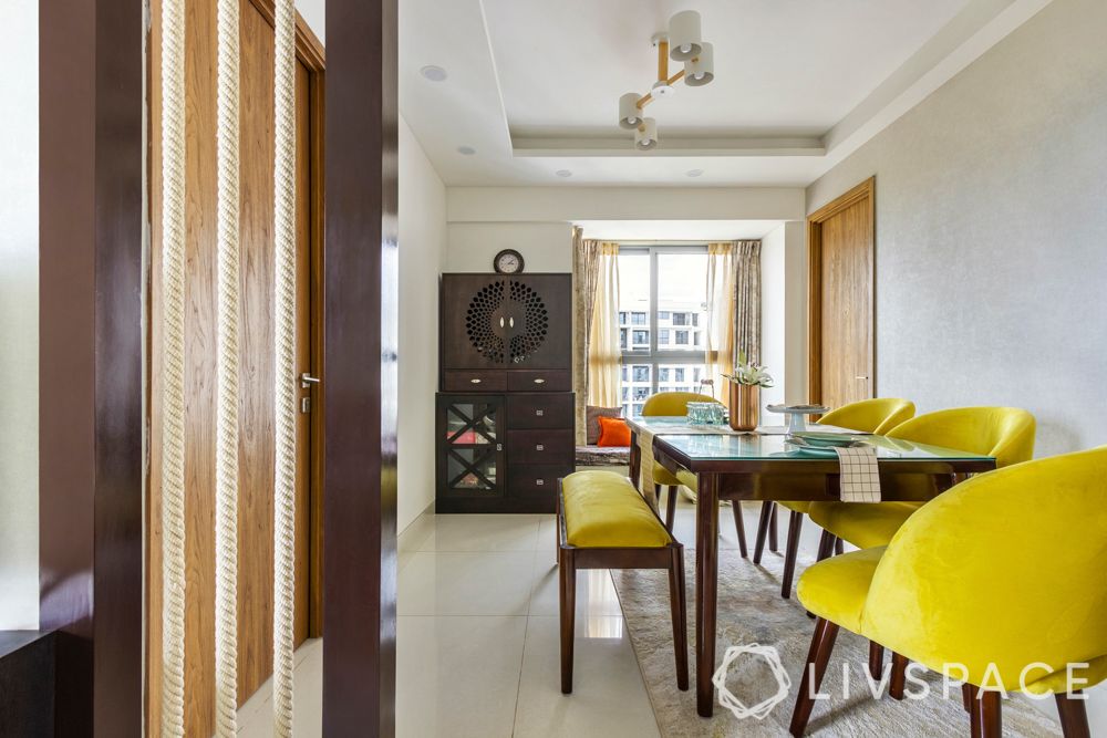 2bhk home design-yellow chairs-dining room-glass top table-rope partition