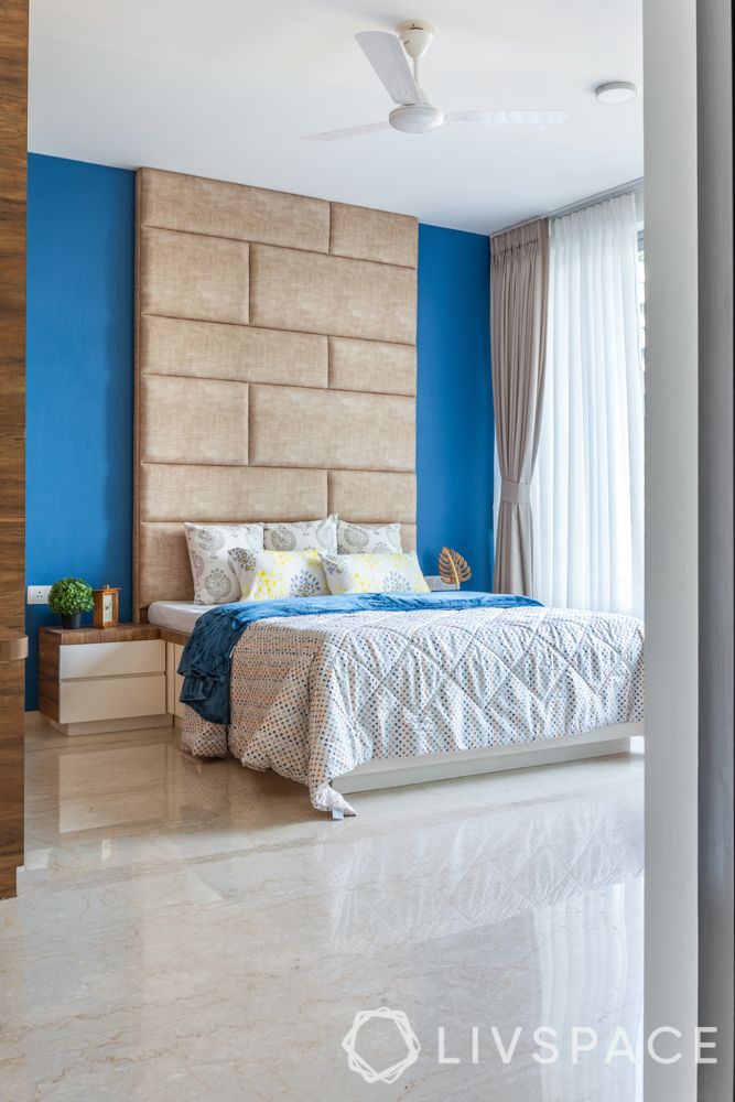beautiful wall designs-full length headboard-suede bed designs-blue wall-wooden wardrobes