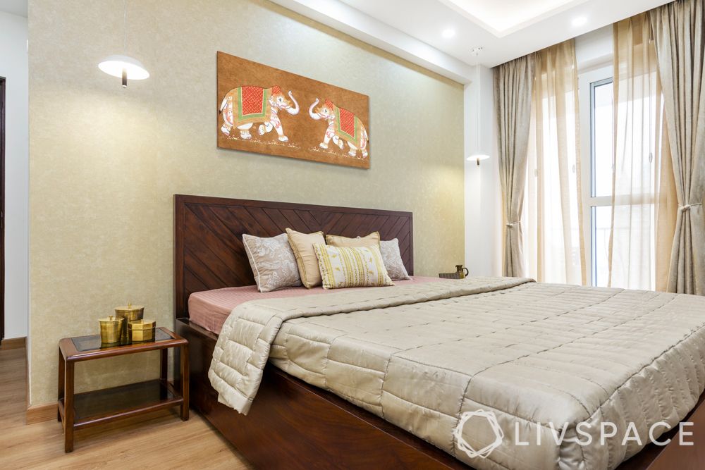 3 bhk design-laminate wardrobes-frosted white-hinged storage-wooden bed-gold wallpaper